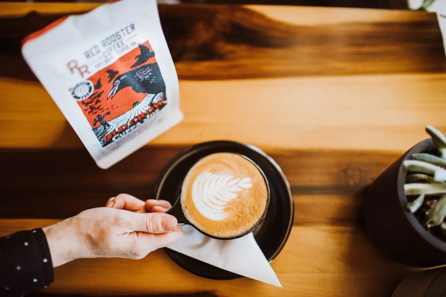 Enjoying A Latte Made With Red Rooster Old Crow Cuppa Joe Coffee