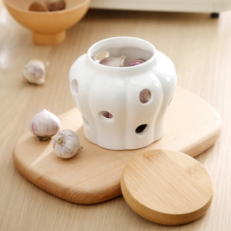Wood Lid And White Ceramic Garlic Pot For Storing Fresh Garlic On Kitchen Counter