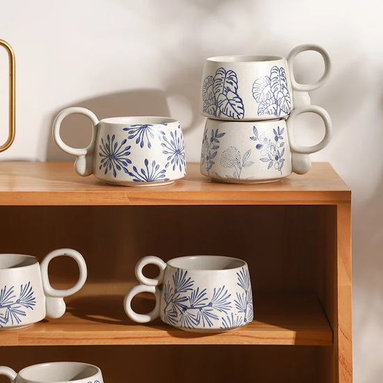 Natural blue patterns with unique handles make these Nature In Blue Ceramic Mugs perfect for front porch sipping in summer.